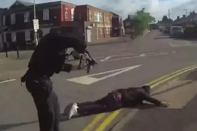 Dramatic moment armed cops swoop on 'cowardly' killer, 39, who stabbed three people as he lies face down in road
