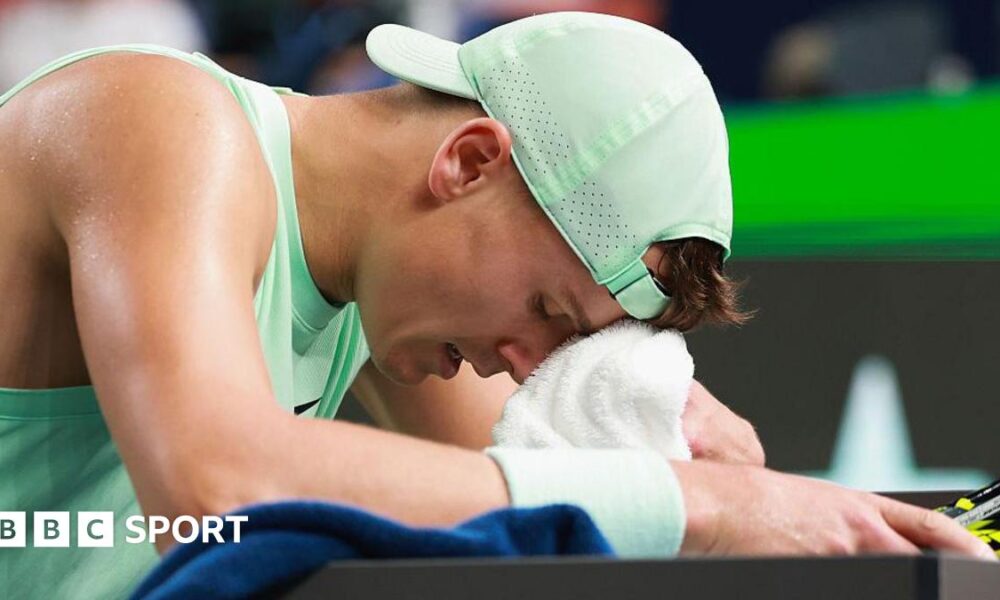 Holger Rune wipes his forehead with a towel during the Shanghai Masters