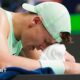 Holger Rune wipes his forehead with a towel during the Shanghai Masters