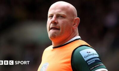 Dan Cole wearing an orange bib over a green Leicester Tigers shirt