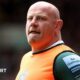 Dan Cole wearing an orange bib over a green Leicester Tigers shirt