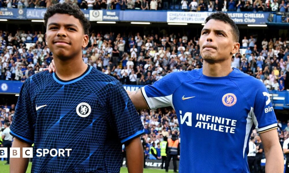 Thiago Silva of Chelsea shows appreciation to the fans with son Isago Silva at full-time after his final appearance