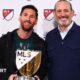 Lionel Messi holding his MLS Most Valuable Player award alongside MLS Commissioner Don Garber.