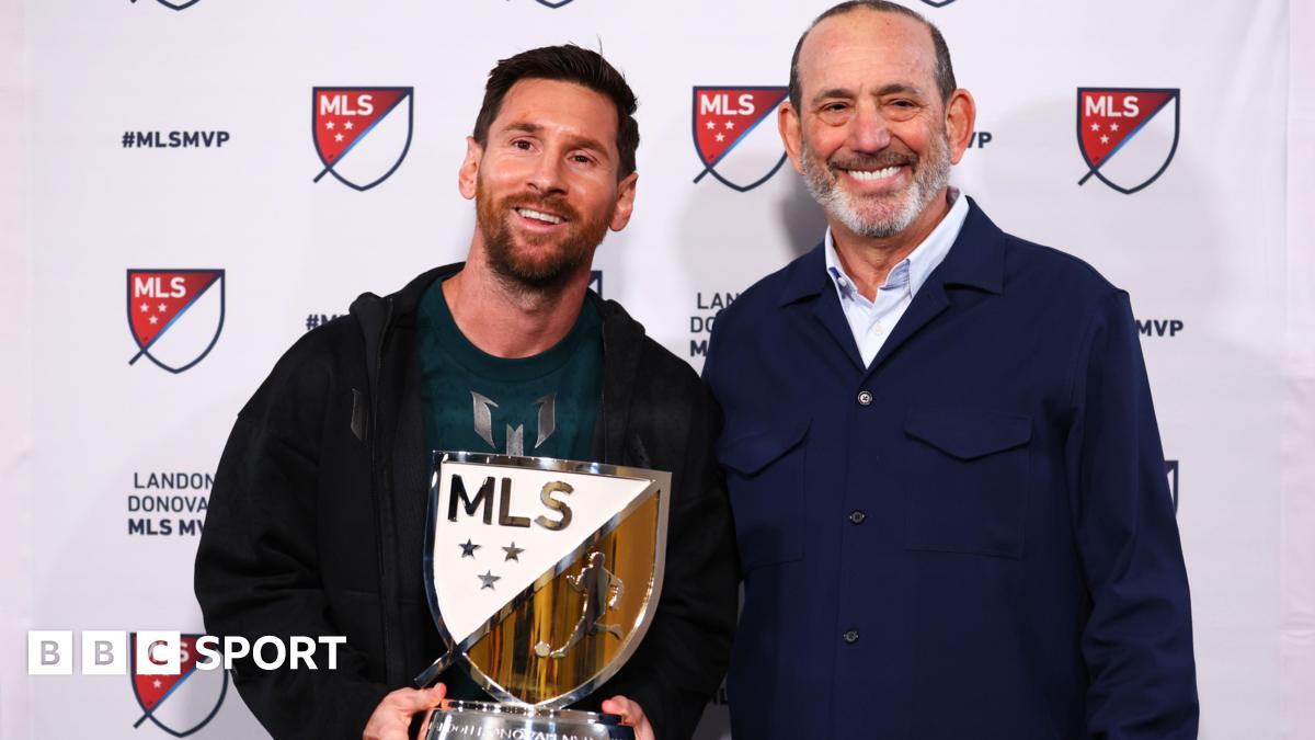 Lionel Messi holding his MLS Most Valuable Player award alongside MLS Commissioner Don Garber.