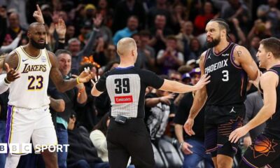 An official comes between Lebron James and Dillon Brooks