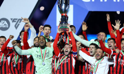 Davide Calabria lifts the Italian Super Cup Trophy after his team