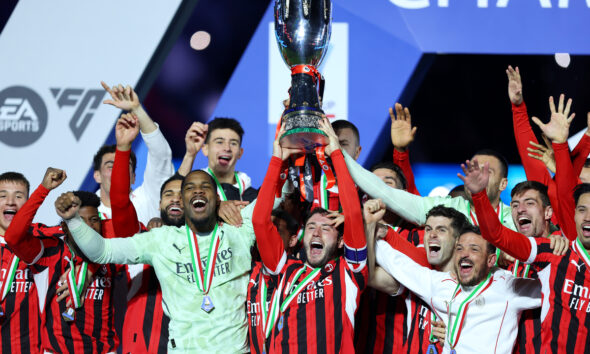 Davide Calabria lifts the Italian Super Cup Trophy after his team