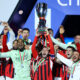 Davide Calabria lifts the Italian Super Cup Trophy after his team