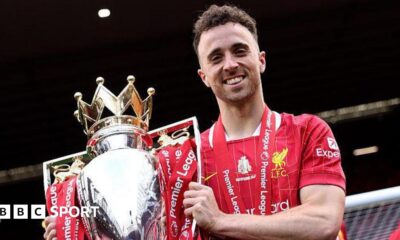 Diogo Jota holding the Premier League trophy while playing for Liverpool in May