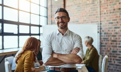 Man sat in boardroom in shirt after expanding his business globally