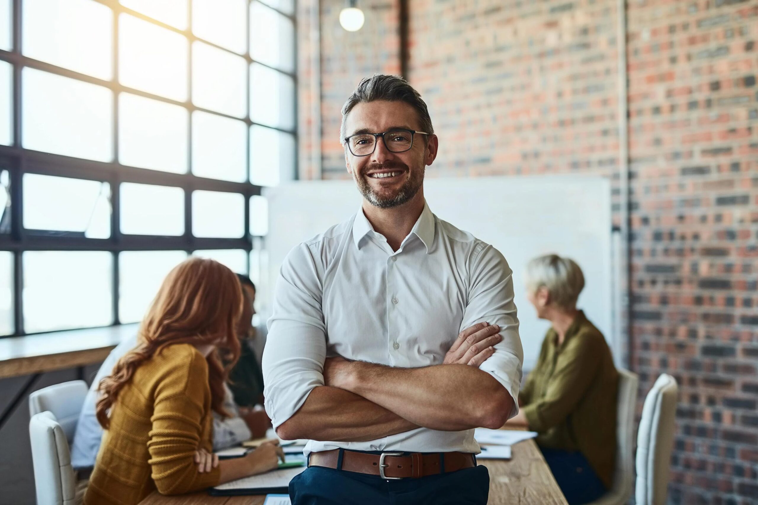 Man sat in boardroom in shirt after expanding his business globally