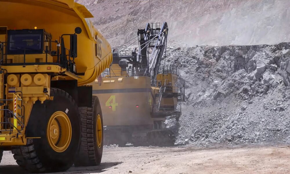 Heavy mining machinery extracting minerals in an open pit mine