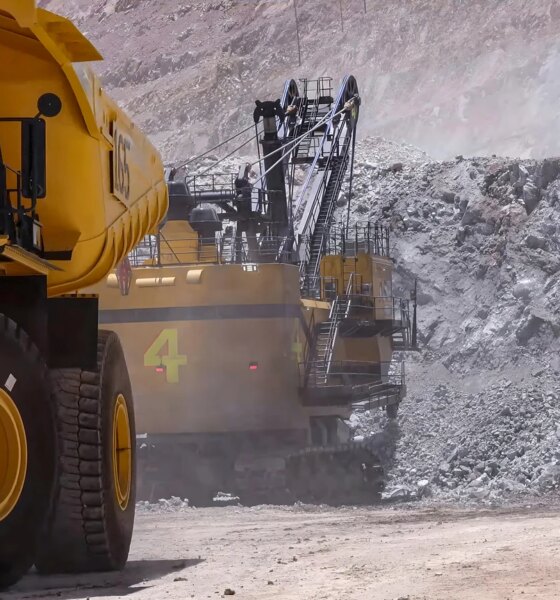 Heavy mining machinery extracting minerals in an open pit mine