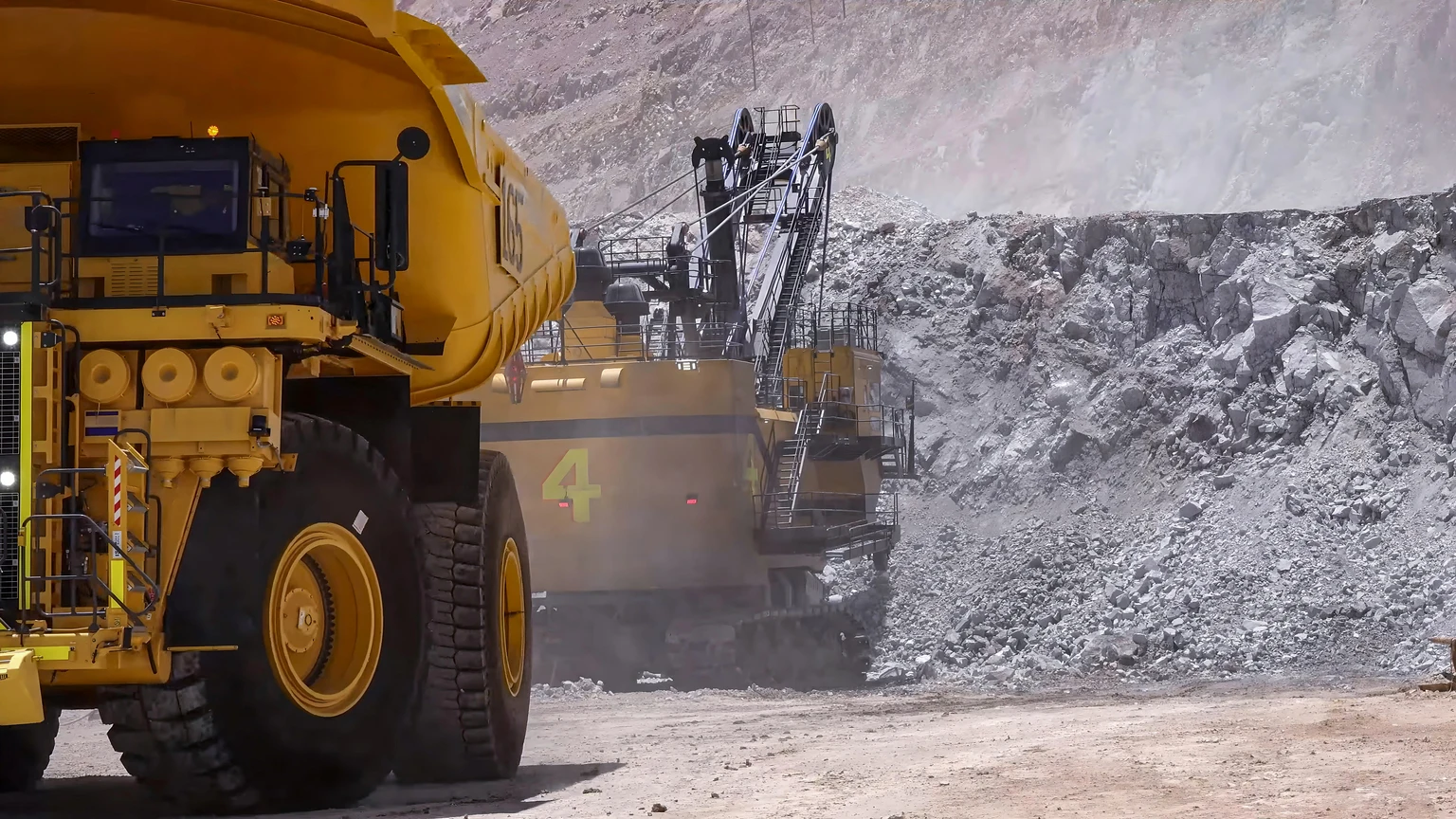 Heavy mining machinery extracting minerals in an open pit mine