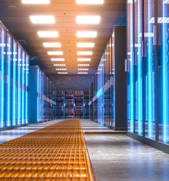 Server room with bright blue lights illuminating the corridor