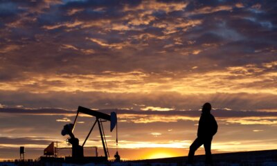 Oilfield Worker or Geologist at Sunrise by Pumpjack