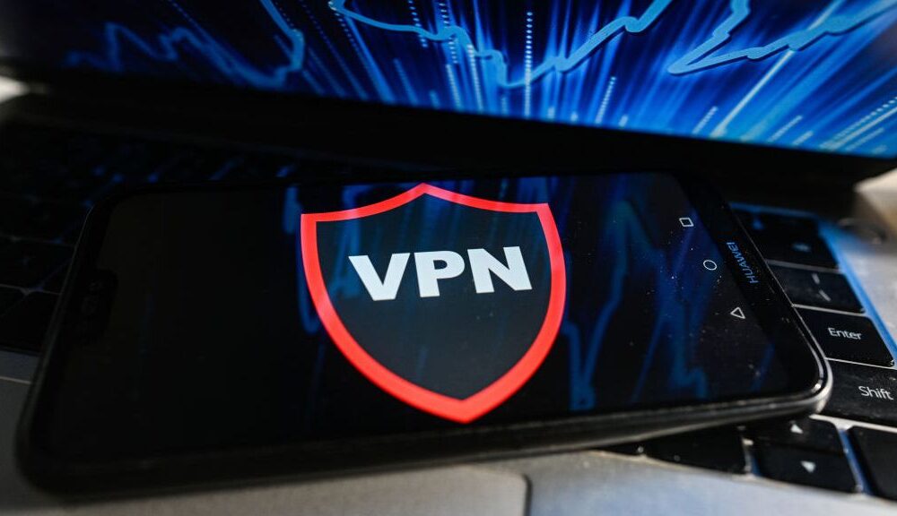 A VPN runs on a mobile phone placed on a laptop keyboard