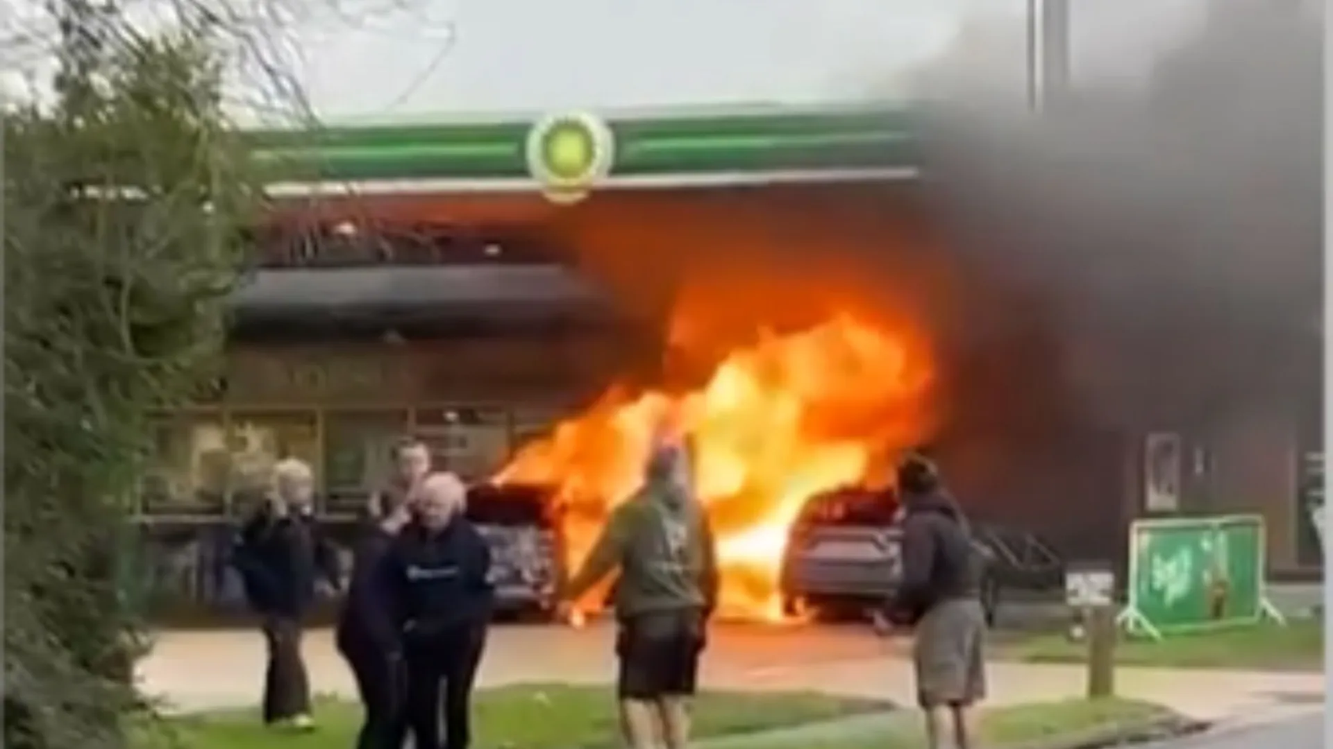 Huge fire erupts at BP petrol station engulfing two vehicles and pump as man seen on forecourt with axe before arrest