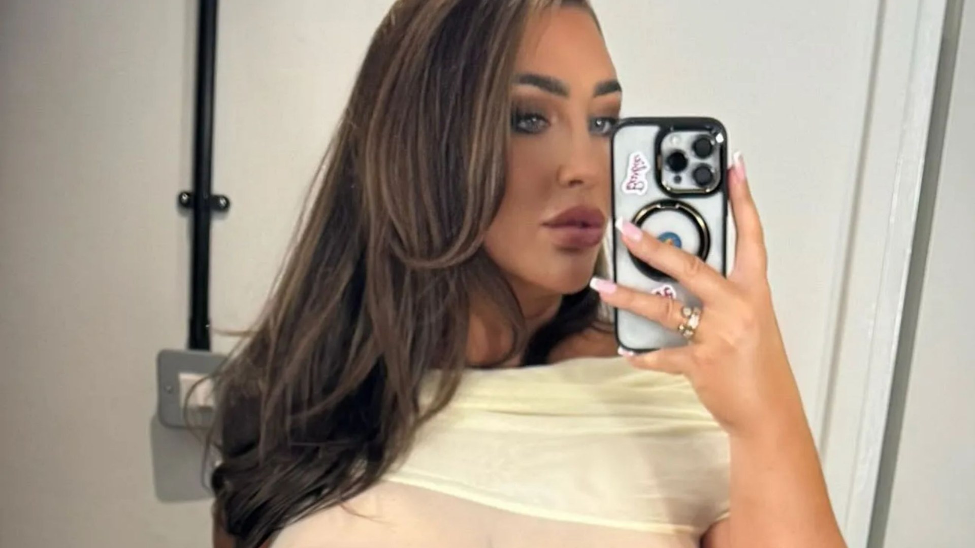 Lauren Goodger shows off very racy Christmas party look as she goes braless in sheer white dress