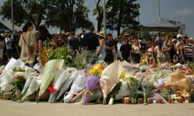 People leave flowers near the scene of the attack at Bondi Beach