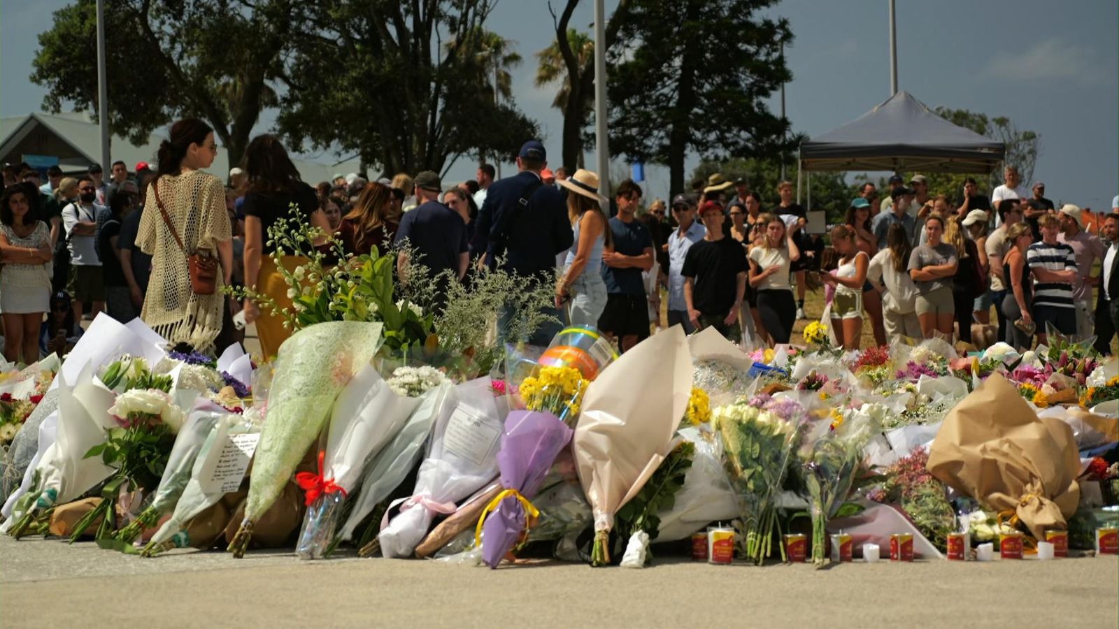People leave flowers near the scene of the attack at Bondi Beach