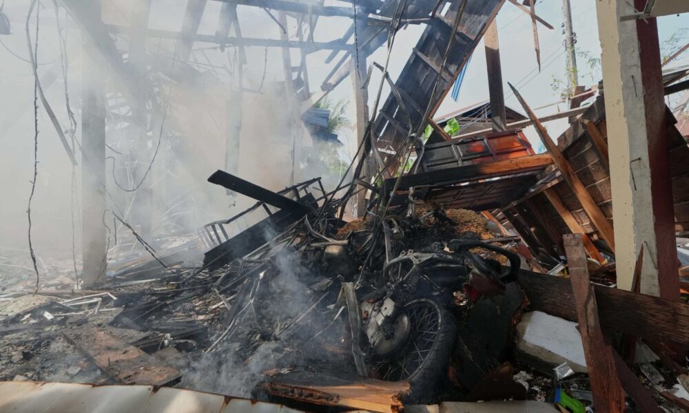 A damaged house after what Thai soldiers said was a Cambodian artillery strike. Pic: AP
