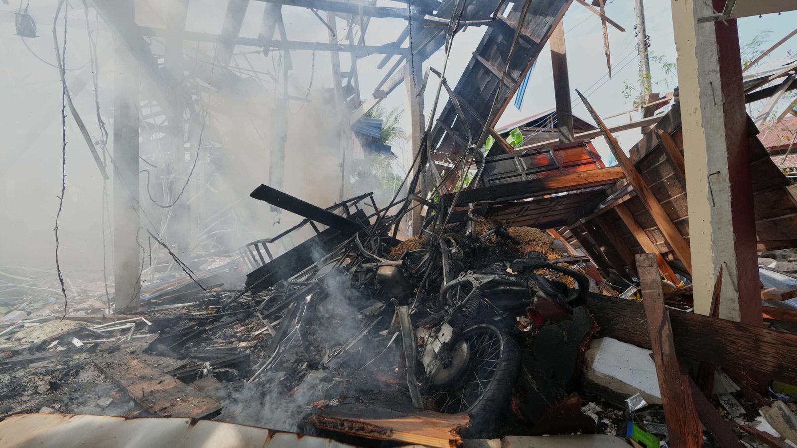 A damaged house after what Thai soldiers said was a Cambodian artillery strike. Pic: AP
