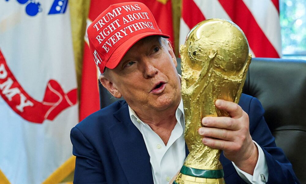 Donald Trump holds the World Cup trophy in August. Pic: Reuters