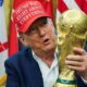 Donald Trump holds the World Cup trophy in August. Pic: Reuters