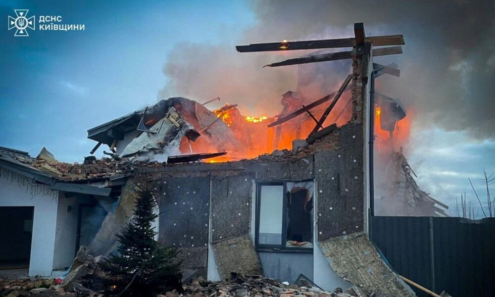 A house burns after it was heavily damaged during Russian early morning drone and missile strikes in Kyiv. Pic: Reuters