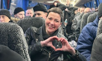 Maria Kolesnikova, making her trademark heart sign, on a coach with released prisoners arriving in Ukraine. Pic: Military Intelligence of Ukraine
