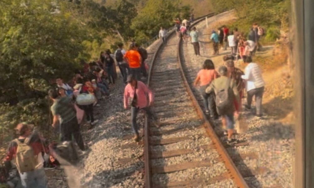 Passengers gather by tracks after a train derailment in Oaxaca state, Mexico. Pic: Social media video via Reuters