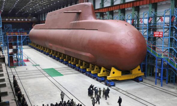 Kim Jong Un visits the construction site of an 8,700-ton nuclear-powered submarine. Pic: KCNA/Reuters