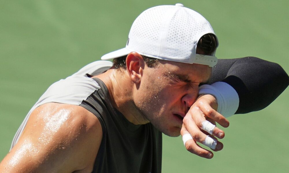 Jack Draper wipes sweat from his face between serves against Federico Agustin Gomez at the US Open