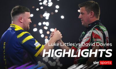 England's Luke Littler (left) shake hands with Wales' David Davies following victory in the Round 2 match on day eleven of the Paddy Power World Darts Championship at the Alexandra Palace, London.