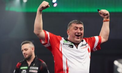Mensur Suljovic celebrates defeating England's Joe Cullen at the World Darts Championship