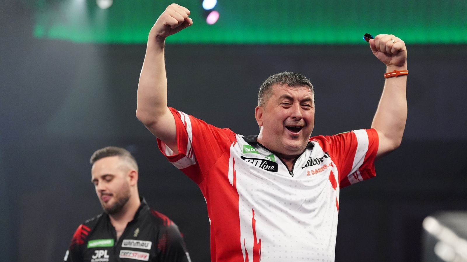 Mensur Suljovic celebrates defeating England's Joe Cullen at the World Darts Championship