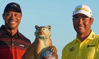 Hideki Matsuyama, of Japan, right, poses for a photo with golf legend Tiger Woods after winning the Hero World Challenge