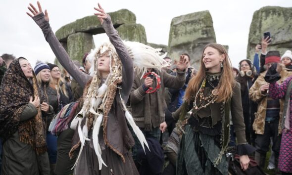 Thousands cheer as the sun rises on winter solstice at Stonehenge