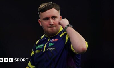 Luke Littler holds up his fist to celebrate