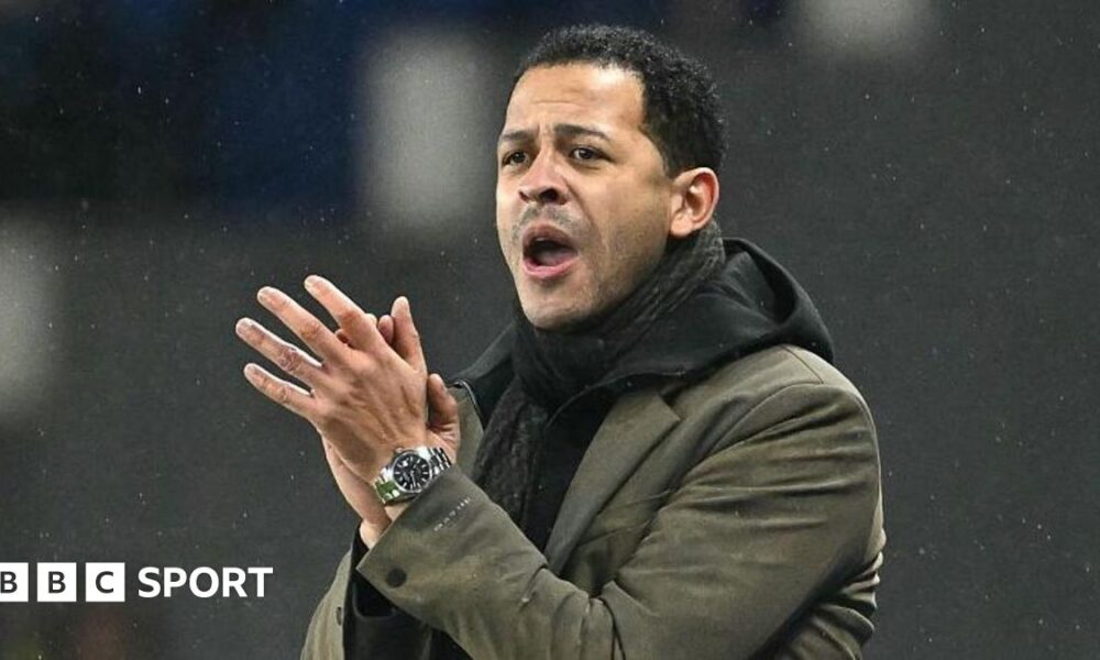 Strasbourg manager Liam Rosenior clapping in the dugout