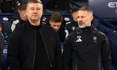 Salford City manager Karl Robinson (L) looks on next to assistant manager Ryan Giggs during the Emirates FA Cup Third Round match between Manchester City and Salford City at Etihad Stadium on January 11, 2025 in Manchester, England