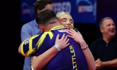BLACKPOOL, ENGLAND - JULY 27: Luke Littler of England embraces Faith Millar after victory in the Final match between James Wade of England and Luke Littler of England on day nine of the 2025 Betfred World Matchplay at Winter Gardens on July 27, 2025 in Blackpool, England. (Photo by Lewis Storey/Getty Images)