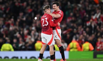 Luke Shaw and Harry Maguire celebrate victory after the UEFA Europa League 2024/25 Quarter Final Second Leg match between Manchester United and Olympique Lyonnais at Old Trafford.