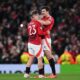 Luke Shaw and Harry Maguire celebrate victory after the UEFA Europa League 2024/25 Quarter Final Second Leg match between Manchester United and Olympique Lyonnais at Old Trafford.