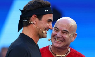 Roger Federer and Andre Agassi laugh during the opening ceremony