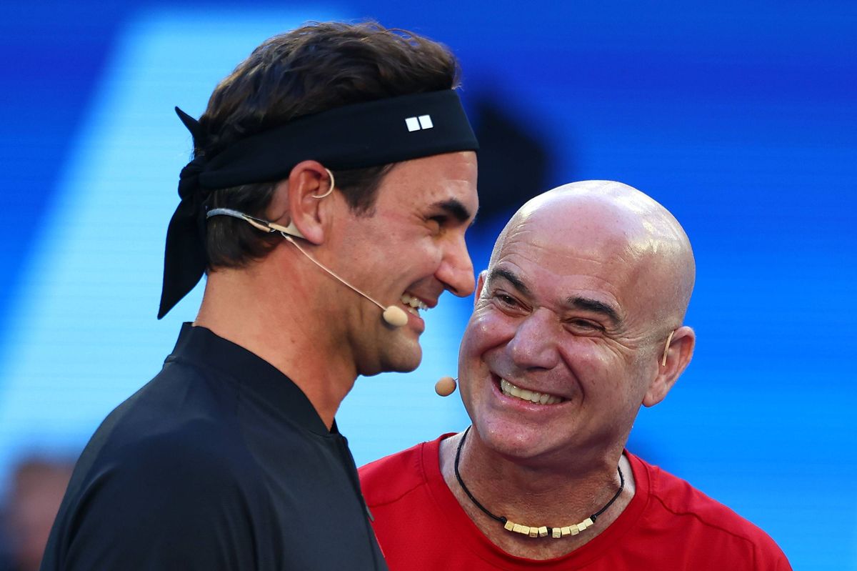 Roger Federer and Andre Agassi laugh during the opening ceremony