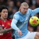 Lisandro Martinez and Erling Haaland fight for possession in the Manchester derby