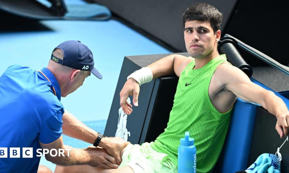Carlos Alcaraz receives treatment during his Australian Open semi-final