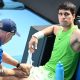 Carlos Alcaraz receives treatment during his Australian Open semi-final